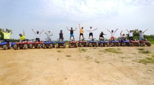 A group cheering on the ATVs